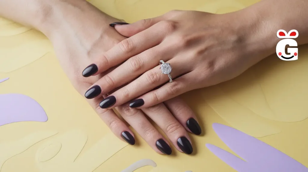 Hands with dark nails and an engagement ring, set against a soft yellow background.